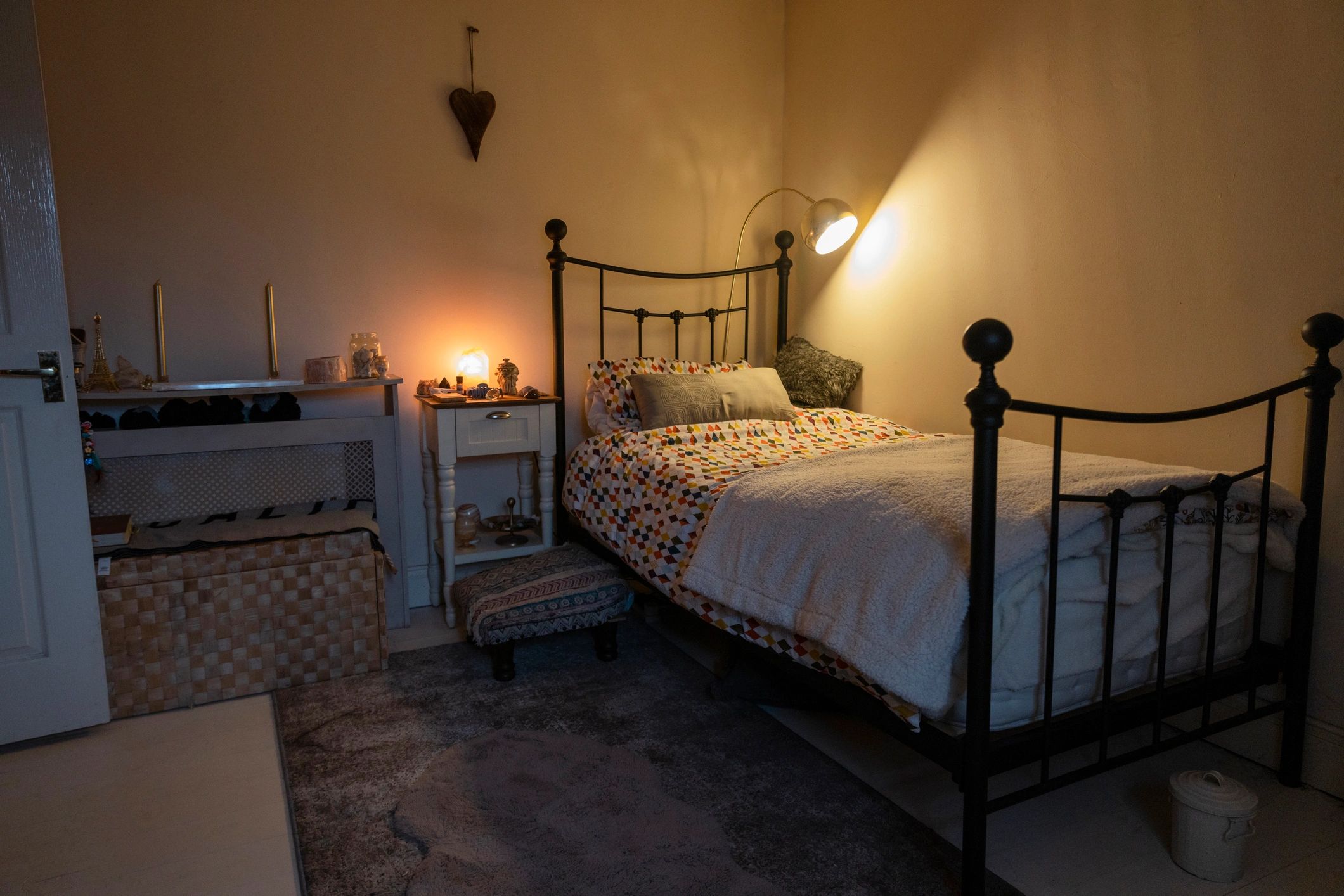 Cozy bedroom with warm lighting and soft bedding