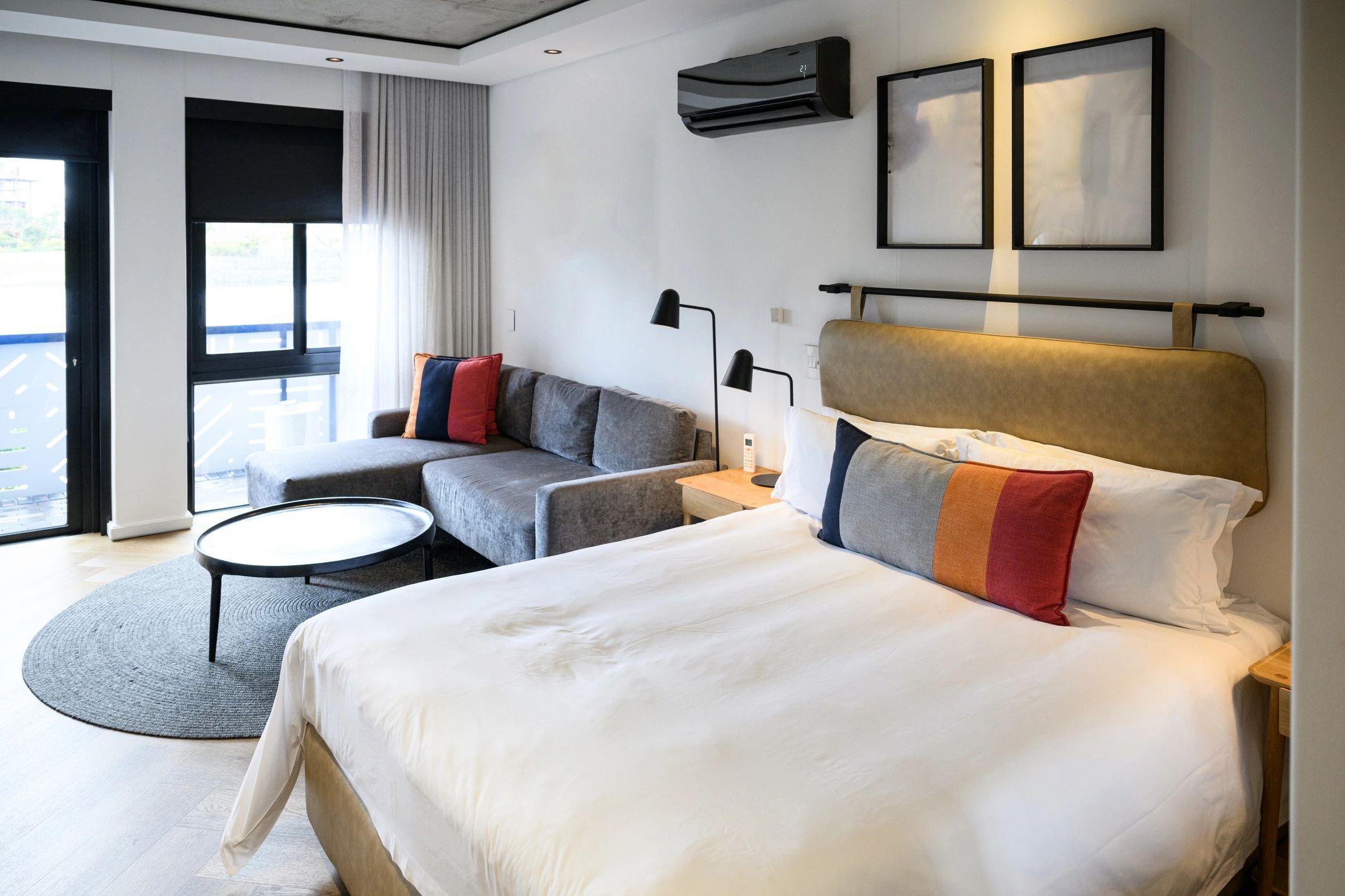 Warm modern bedroom with neatly styled bedding